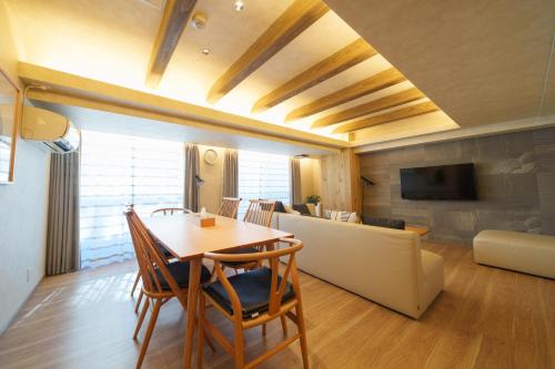 a living room with a table and a couch at PREMIER suite Shinjuku West 3F 4F in Tokyo