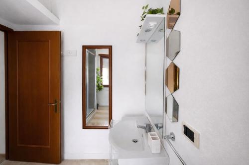 a bathroom with a sink and a mirror at Villa summertime walking distance from the sea with garden in Fregene
