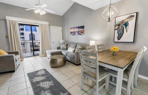 a living room with a table and a couch at Sugar Beach 330 Family Friendly Vacation Sleeps 8 in Gulf Shores