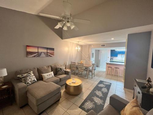 a living room with a couch and a table at Sugar Beach 330 Family Friendly Vacation Sleeps 8 in Gulf Shores