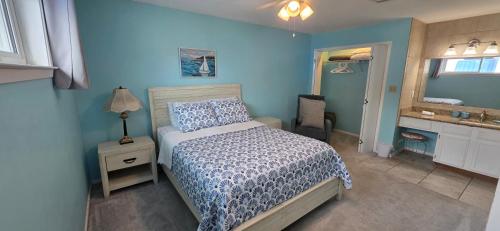 a blue bedroom with a bed and a sink at Sugar Beach 330 Family Friendly Vacation Sleeps 8 in Gulf Shores
