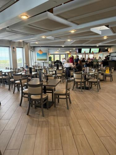 a dining room with tables and chairs in a restaurant at Casa SolMar in Fort Pierce