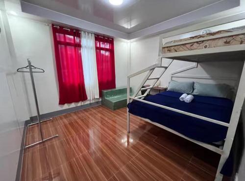 a bedroom with a bunk bed and a wooden floor at Two-Storey Townhouse in Laguindingan
