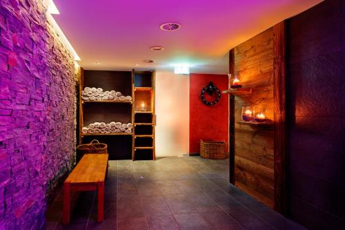 a room with a wooden table and a brick wall at Hotel Bristol in Zermatt