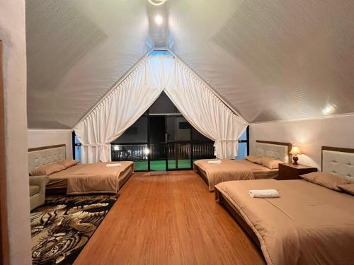 a room with three beds in a tent at DIENG CAKRAWALA CABIN Tambi Syariah in Kejajar