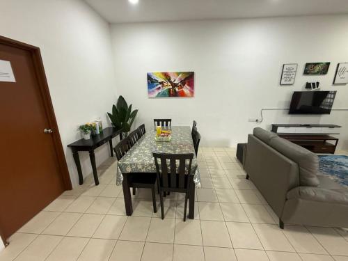 a living room with a table and a couch at Hasna Homestay Cherating Muslimonly in Kuantan