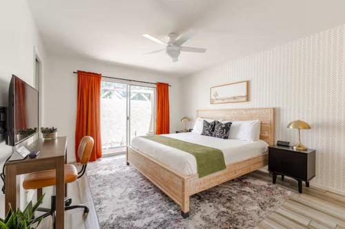 a bedroom with a bed and a desk and a window at Central Phoenix Townhome in Phoenix