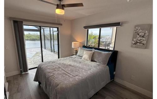 a bedroom with a bed with a view of the water at Sandi Villa in Cape Coral