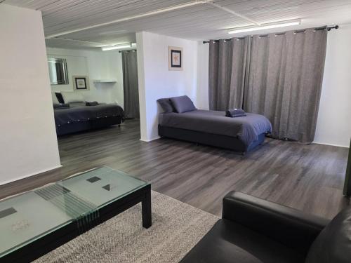 a living room with a couch and a bed and a table at Tranquility Studio Two in Mission Beach