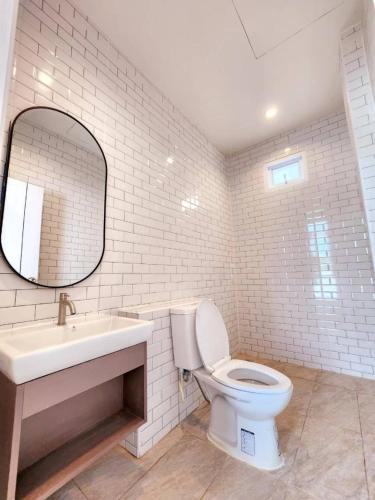 a bathroom with a toilet and a sink and a mirror at Benjavipa Pool Villa Khao yai in Ban Nong Song Hong