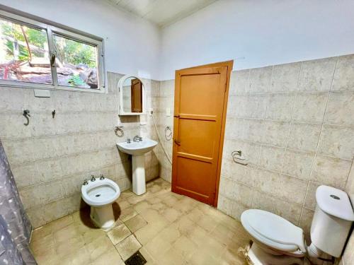 a bathroom with two toilets and a sink at Casa del lago in Embalse