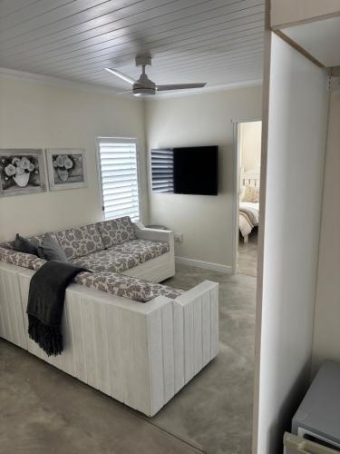 a living room with a couch and a flat screen tv at Seascape in Dwarskersbos