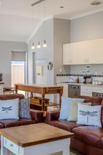 a living room with two couches and a table at Albany Bayside by the BnB Collection in Albany