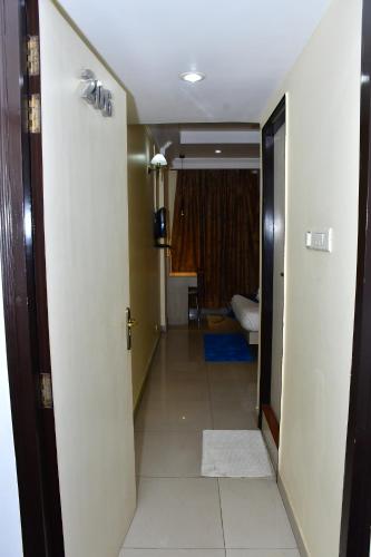 a hallway with a hallway leading to a room at The Rass in Kānpur