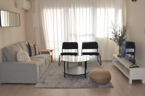 a living room with a couch and a table and chairs at Cozy Family Room in Matsumoto 201 in Matsumoto