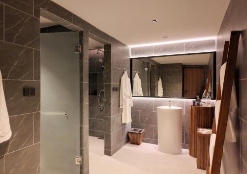 a bathroom with a shower with a glass door at Khunkhao Paradise Khao Yai in Ban Rai Khlong Sai