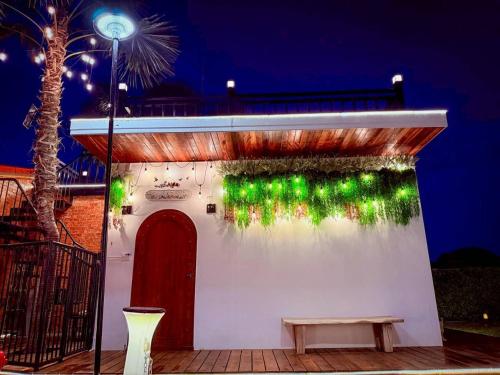 a small white building with green lights on it at Apinya Resort Bangsarey in Ban Tao Than