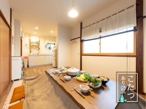 a kitchen with a table with food on it at 亀のや 駅徒歩7分 空港Disney直通 SKACこち亀記念館 in Tokyo
