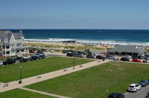 a view of a beach with cars parked on a street at The Ocean Plaza Hotel in Ocean Grove