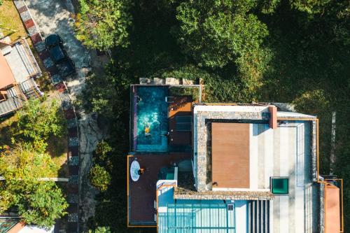 an overhead view of a house with a pool at Sky Hill Villa SuratThani in Suratthani
