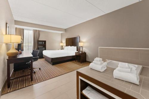 a hotel room with a bed and a desk at Comfort Inn Lehigh Valley West in Fogelsville