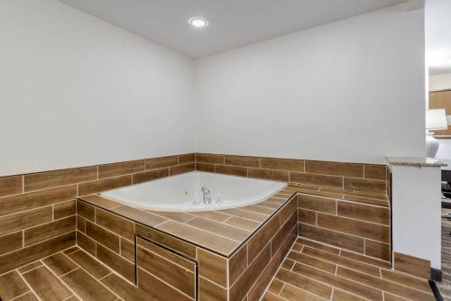 a bath tub in a bathroom with white walls and wooden floors at Quality Inn & Suites South Fork - Wolf Creek in South Fork
