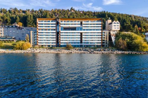 a large building on the shore of a body of water at Radisson Blu Bariloche in San Carlos de Bariloche