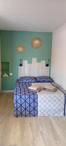 a bedroom with a bed in a room with green walls at bambou studio in Les Avirons