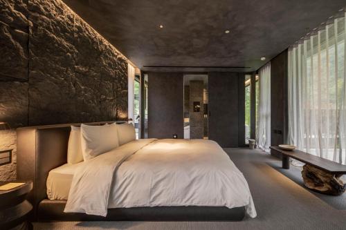 a bedroom with a large bed and a large window at Sokali Maho 蘇卡利 漫活 in Chung-chih-ts'un
