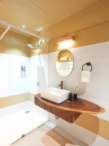 a bathroom with a sink and a mirror at Tamarind Retreat in Alibaug