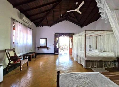 a bedroom with a bed and a ceiling fan at Priyanka Villa in Bentota