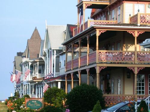 a large building with american flags on its balconies at The Ocean Plaza Hotel in Ocean Grove