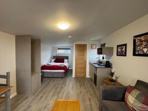 a living room with a bed and a couch at Inverness Ardtower Escapes in Culloden