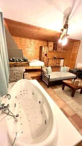 a bathroom with a bath tub in a room at Suites Efharis Filoxenon in Feneos