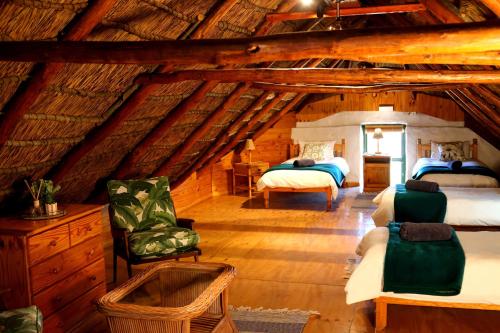 a bedroom with two beds in a attic at Heiveld Farm Cottages in Ceres
