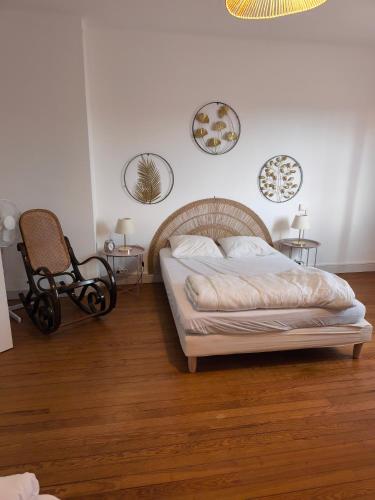 a bedroom with a bed and a chair in it at Maison familiale in Orleix