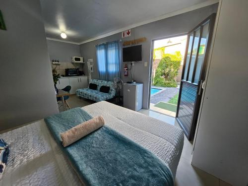 a bedroom with a bed and a door to a patio at Zufike Self Catering in Port Elizabeth