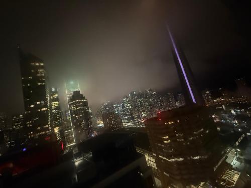 a view of a city skyline at night at Chol Furnished Suites 2 Bedrooms Downtown Toronto Million Dollar CN Tower View MTCC Rogers Centre Blue Jays TIFF Free Parking in Toronto