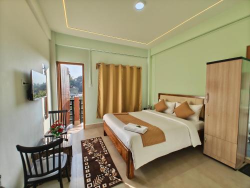 a bedroom with a large bed and a window at Kaizen Stay-Inn in Jowai