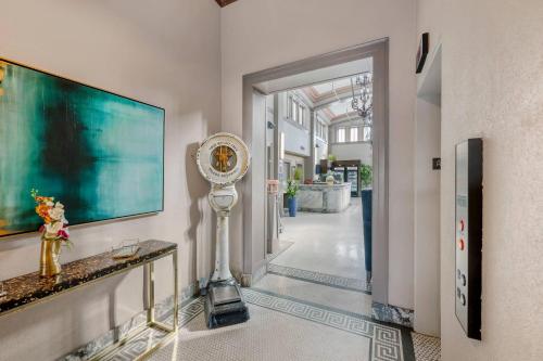 a room with a hallway with a clock on a wall at Hotel 1914 - Historic Alamo Riverwalk, an Ascend Collection Hotel in San Antonio