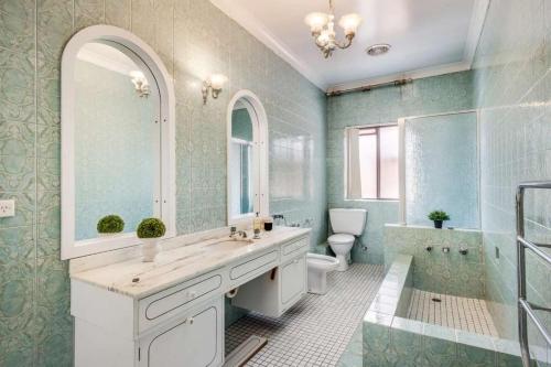 a bathroom with a sink and a tub and a toilet at Comfortable House-shared accommodation in Bankstown