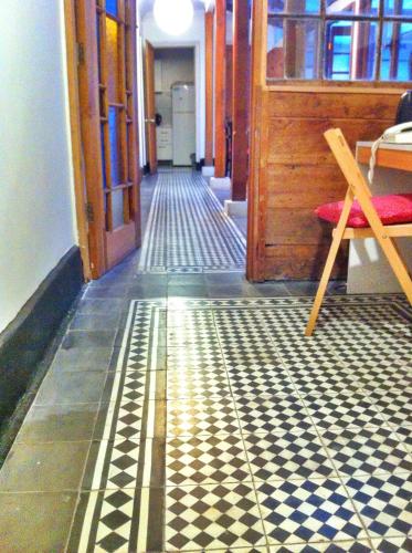 a hallway with a checkered floor in a room at Tralkan B&B in Santiago