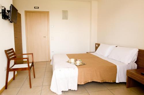 a bedroom with a bed with a table and a chair at B&B Daniel in Silea