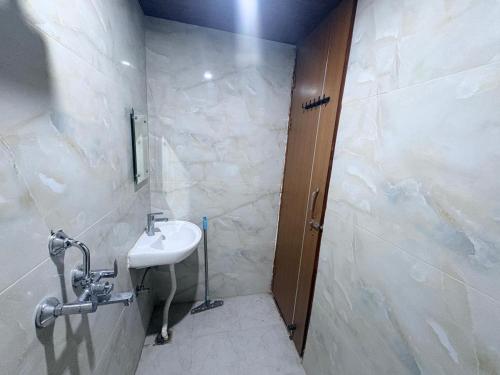 a bathroom with a sink and a shower at Hotel 69 in Gurgaon