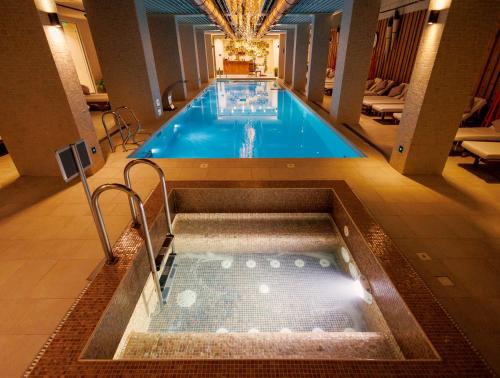 a pool in a hotel with a hot tub at Lucky Bansko Aparthotel SPA & Relax in Bansko