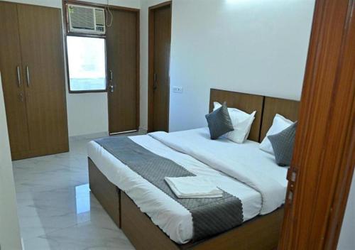a bedroom with a large bed in a room at Hotel 69 in Gurgaon