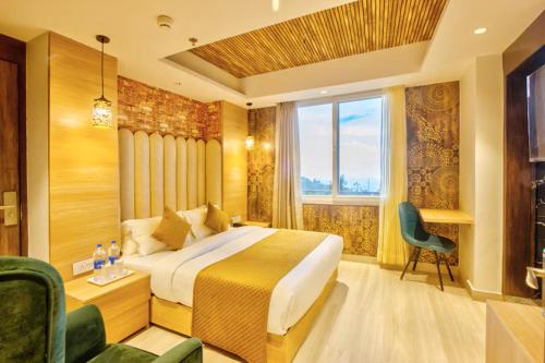 a hotel room with a bed and a window at Hotel Katson Castle with Sunset View Dharamshala in Dharamshala