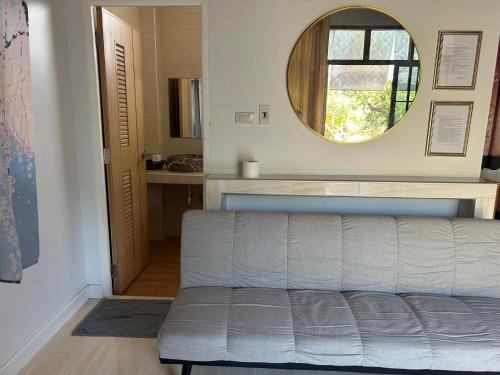a living room with a couch and a mirror at NAPA CHATEAU Resort in Ban San Khu