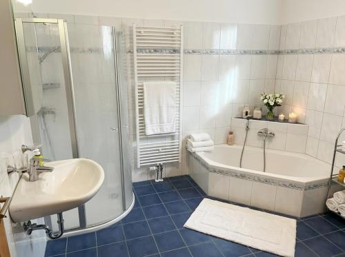 a bathroom with a tub and a sink and a shower at Bergperle am Lindberg in Perlesreut