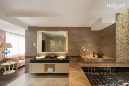 a bathroom with a sink and a mirror at Silverland Jolie Hotel in Ho Chi Minh City